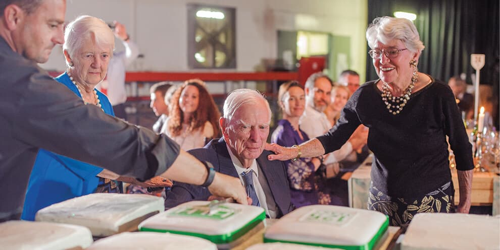 Several generations of the family gathered around Halls-crested celebration cakes