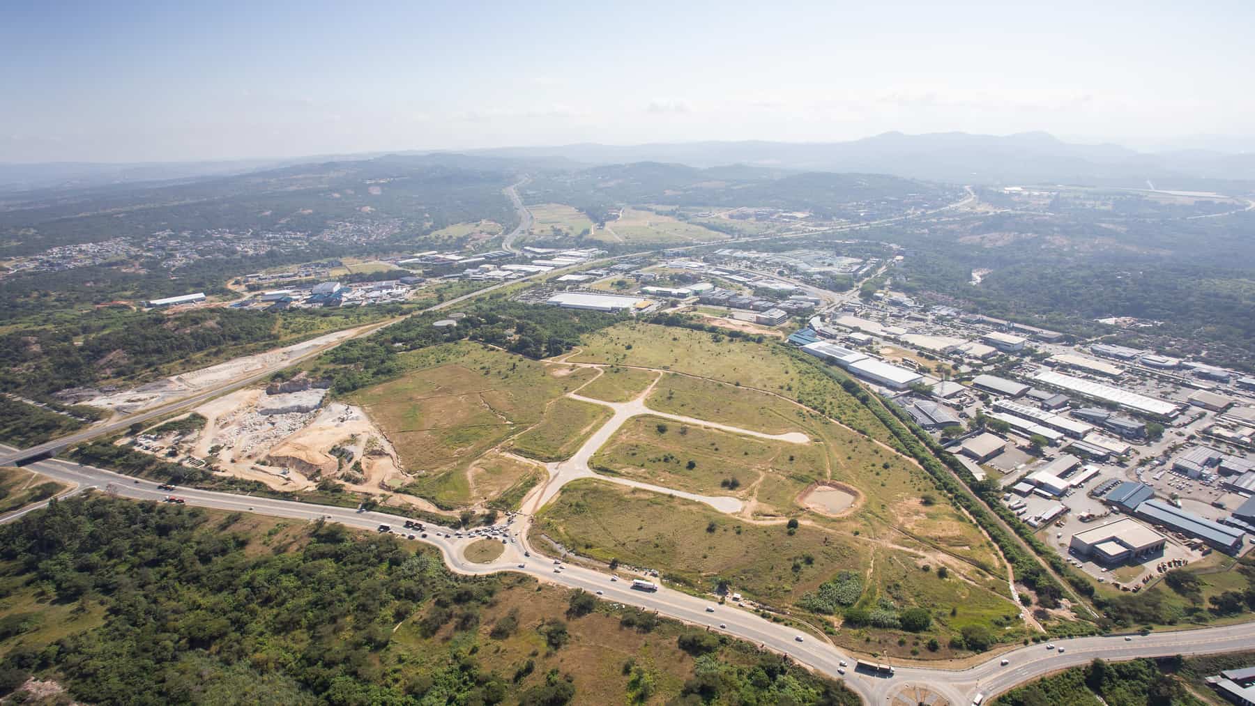 Aerial view of a serviced development site, roads laid out across open land